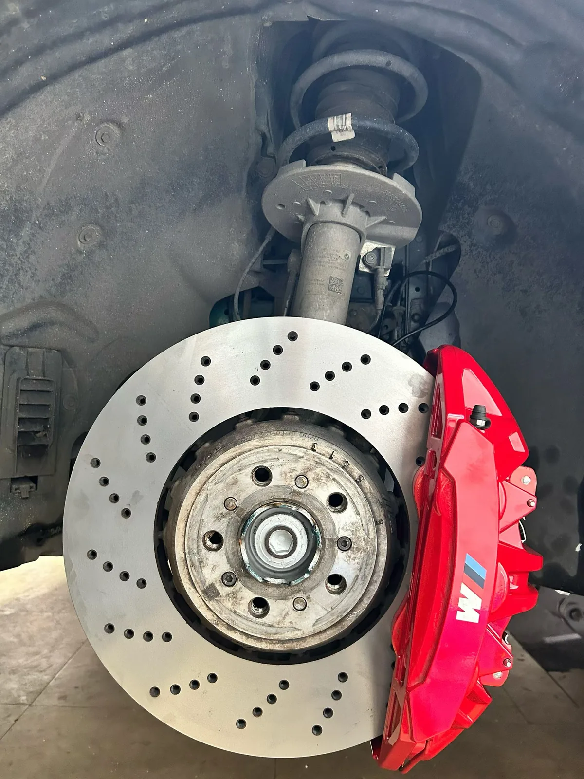 New drilled brake rotor and serviced M caliper installed on BMW M3
