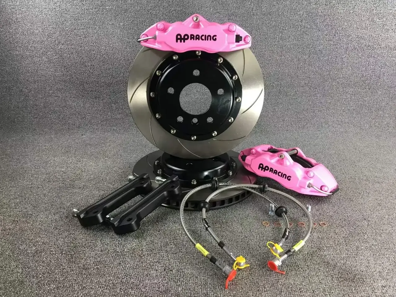 Custom pink caliper refinish on a full big brake kit with slotted rotors and lines