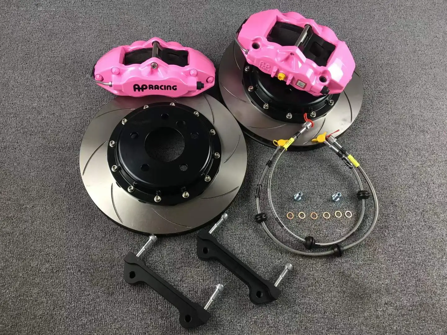 Custom pink refinished calipers with slotted rotors and stainless brake lines