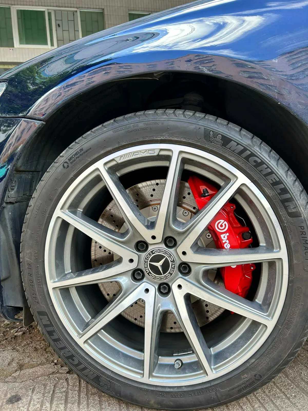 380mm drilled rotor paired with red Brembo V6 caliper behind Mercedes E260 wheel