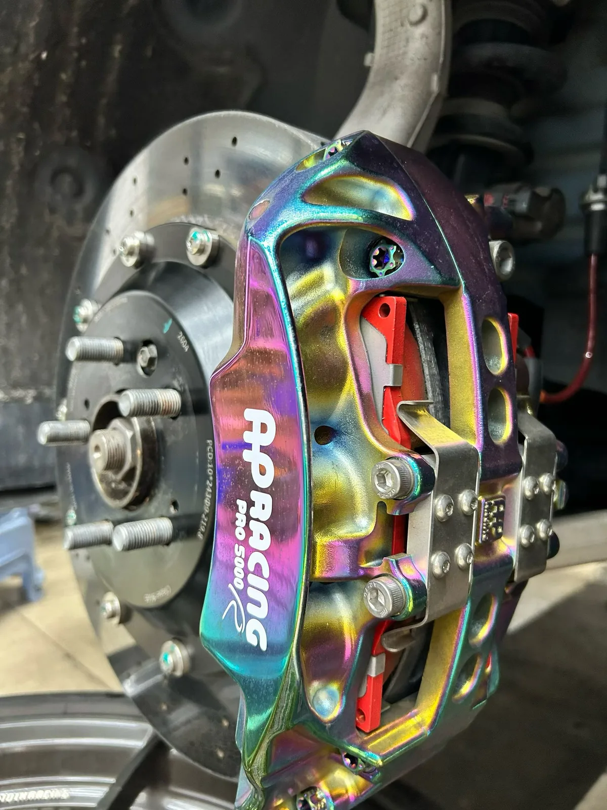Neo-chrome finished caliper on Tesla Model 3 carbon-ceramic brake rotor